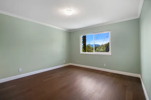 a view of a room with wooden floor and window