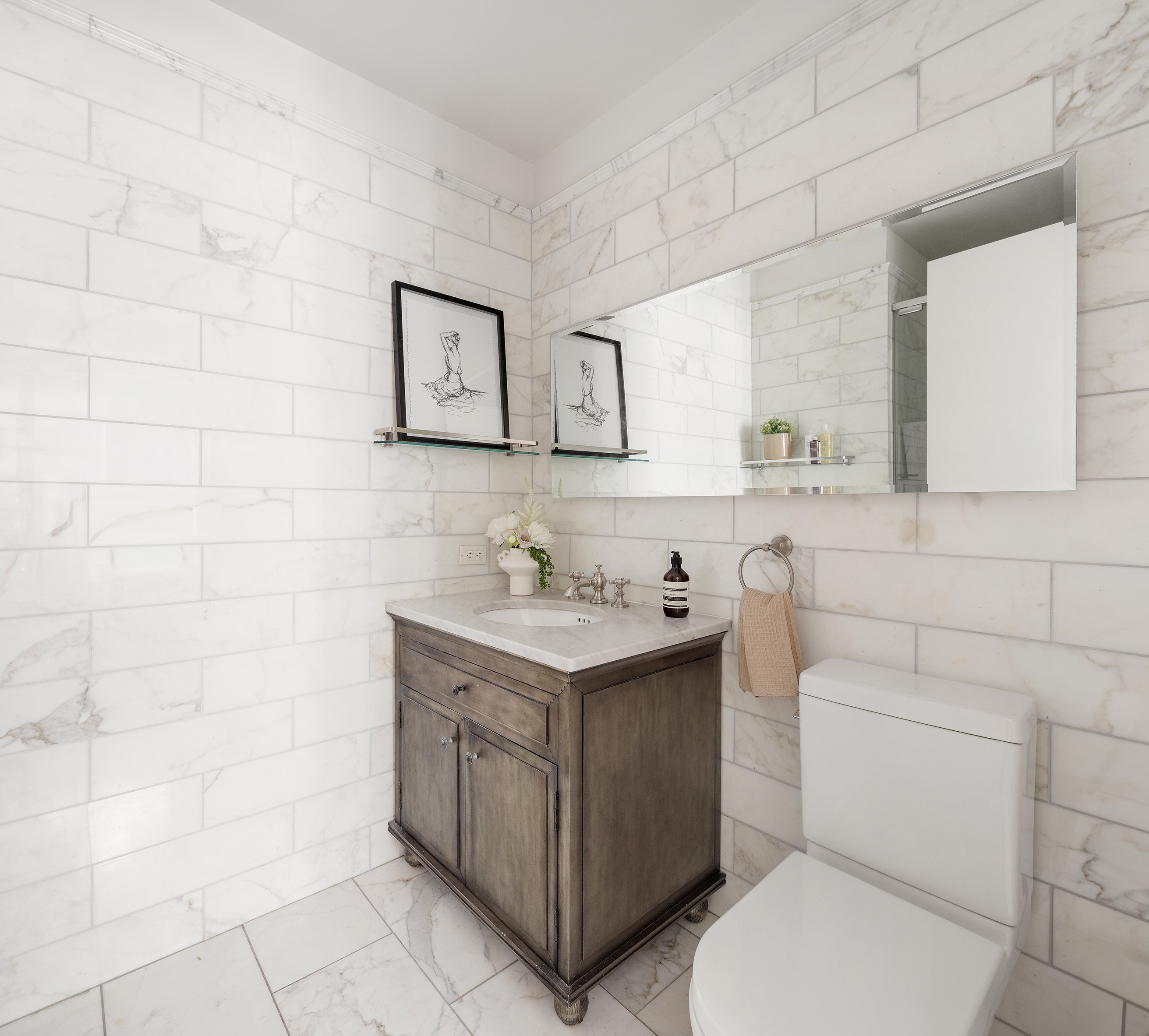 225 5th Avenue, Unit 6T Manhattan, NY 10010 - Photo 8 of 12 a bathroom with a sink toilet and mirror