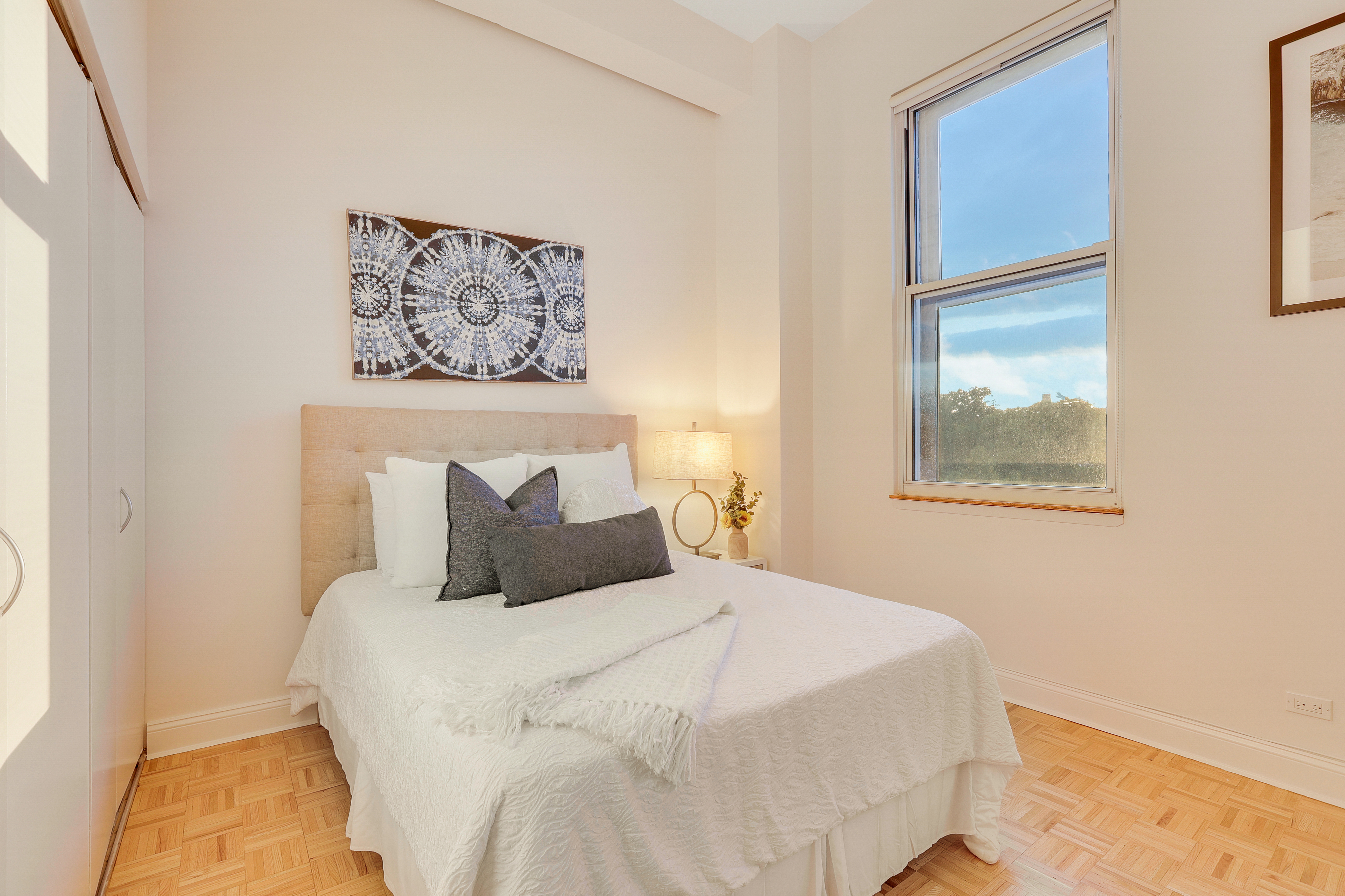 1255 5th Avenue, Unit 5B Manhattan, NY 10029 - Photo 11 of 12 a bedroom with a bed and a window