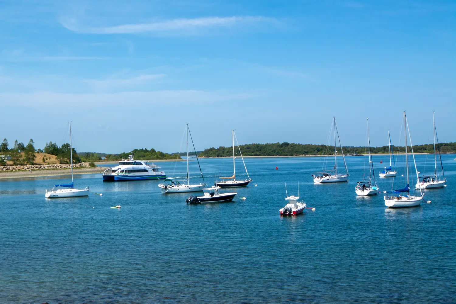 a view of a lake with lawn chairs
