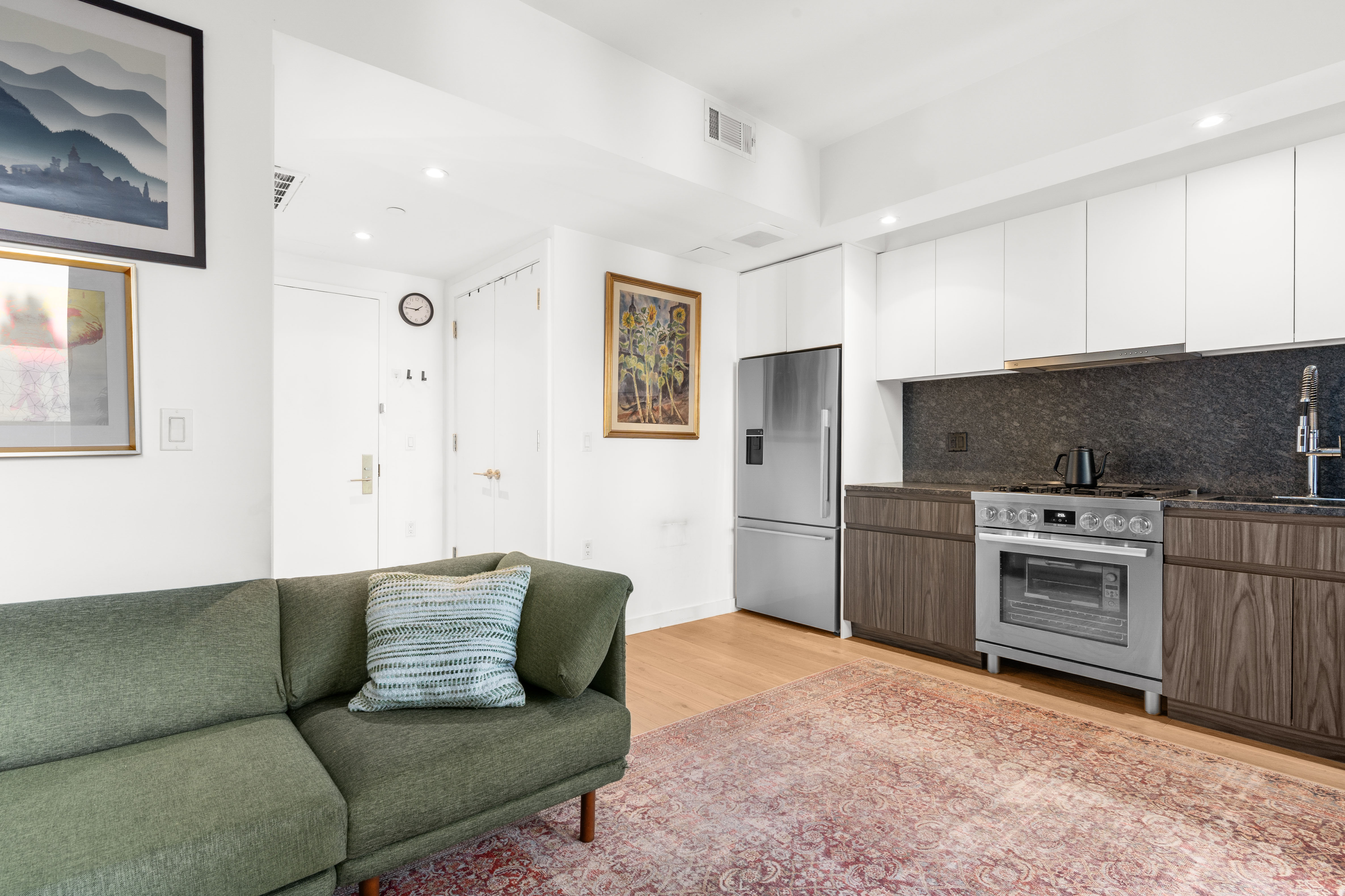 435 Tompkins Avenue, Unit 303 Brooklyn, NY 11216 - Photo 3 of 10 a living room with a couch and a stove top oven