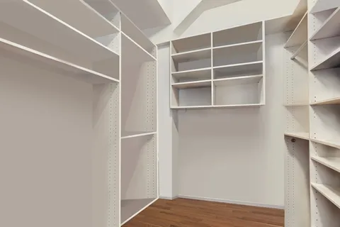 a view of walk in closet with empty racks