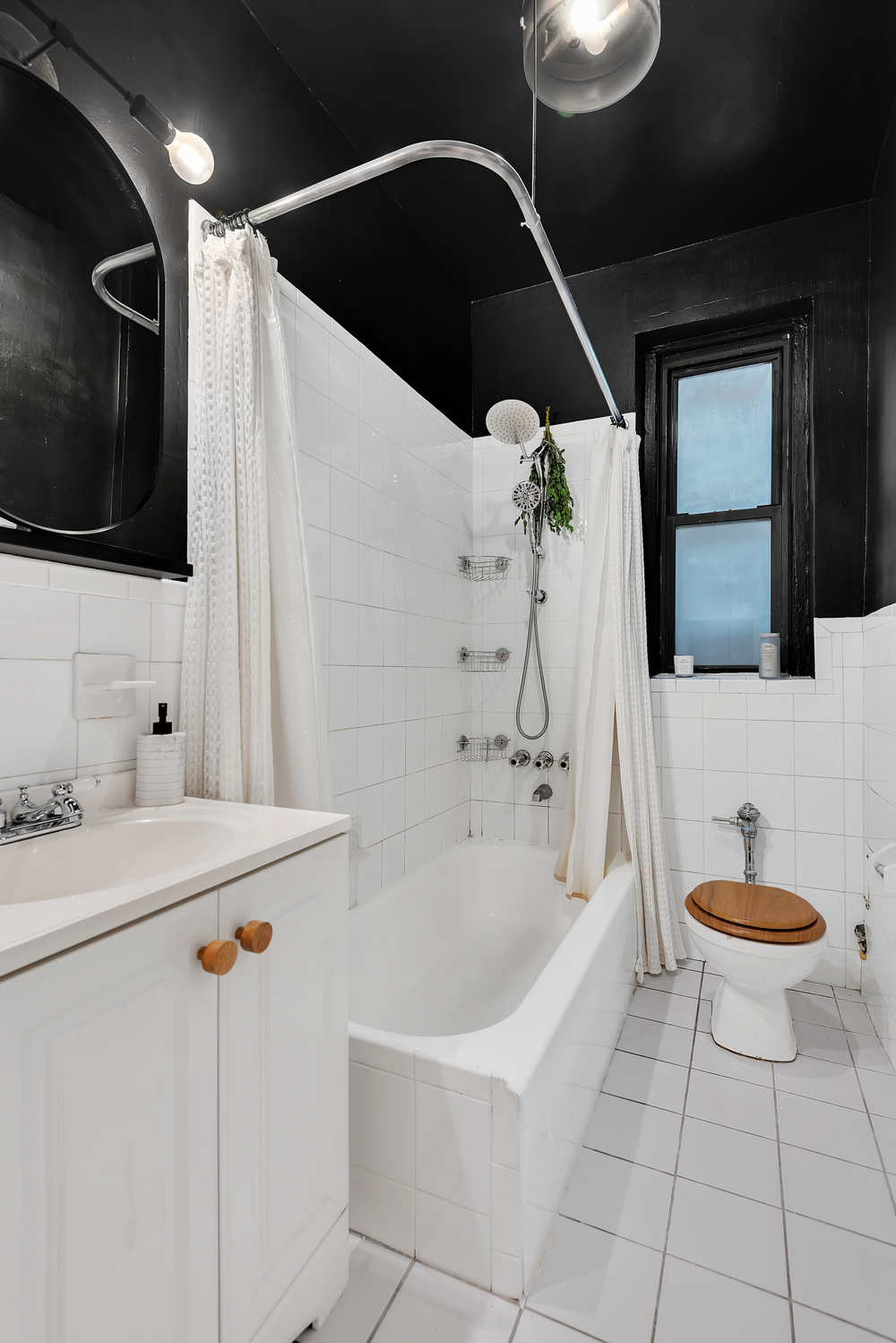 166 East 92nd Street, Unit 1D Manhattan, NY 10128 - Photo 5 of 6 a bathroom with a sink a toilet and bathtub