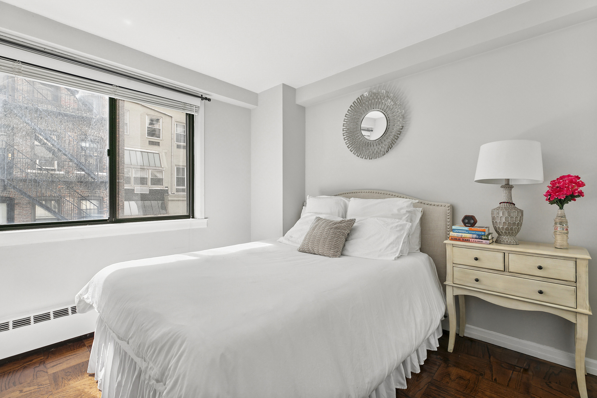 16 West 16th Street, Unit 3RN Manhattan, NY 10011 - Photo 4 of 9 a bedroom with a bed and a window