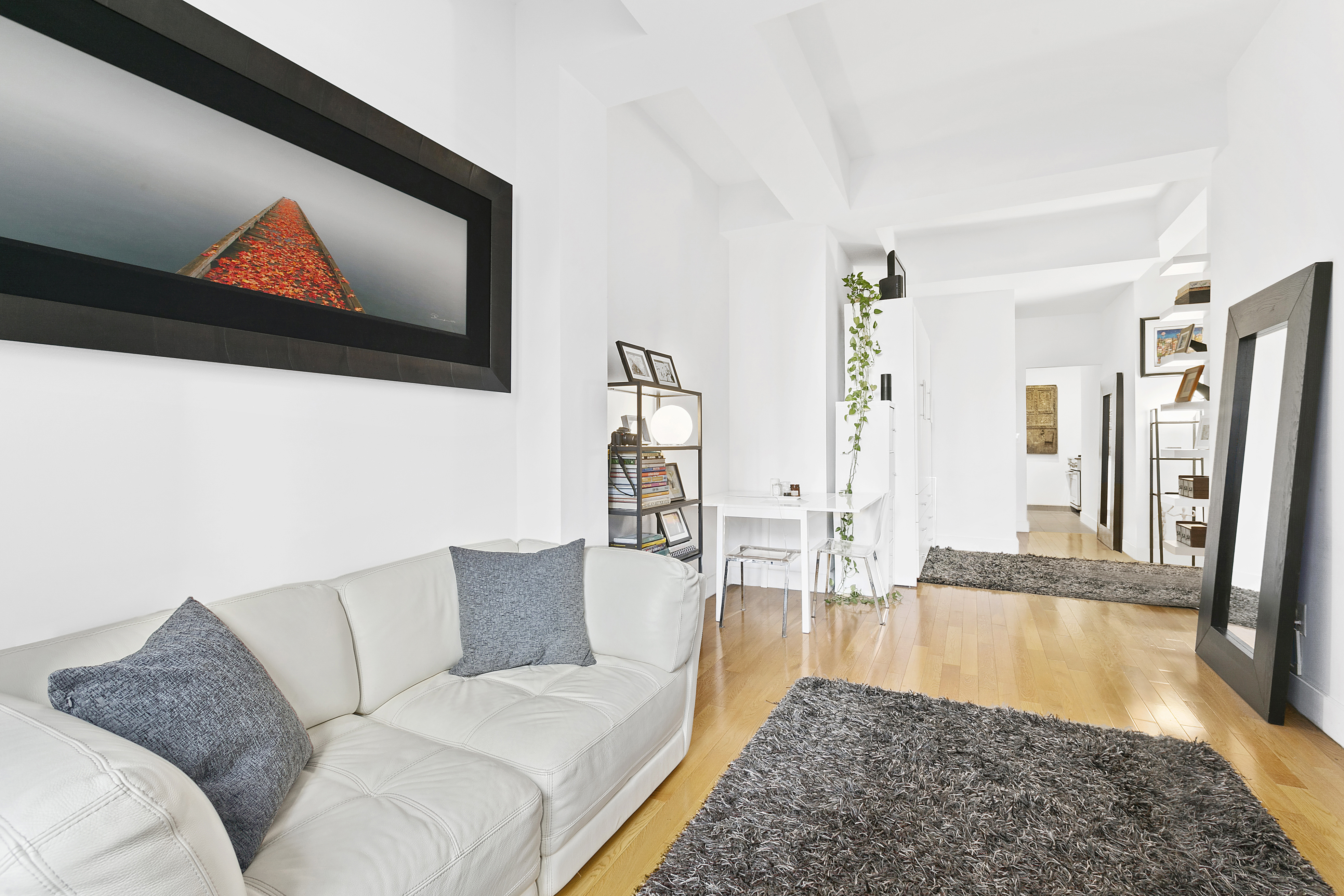 99 John Street, Unit 1101 Manhattan, NY 10038 - Photo 2 of 16 a living room with furniture and a flat screen tv