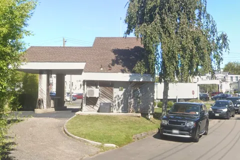 a front view of a house with outdoor seating