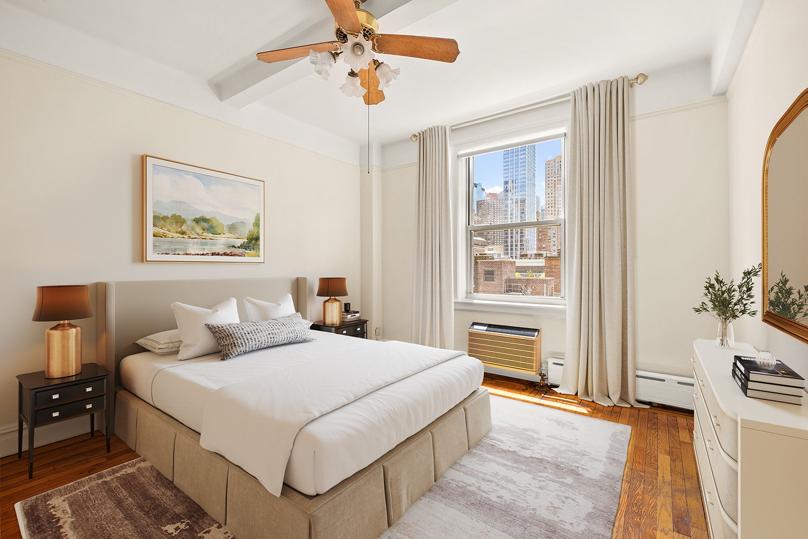 345 West 55th Street, Unit 8AB Manhattan, NY 10019 - Photo 4 of 14 a bedroom with a large bed and a chandelier