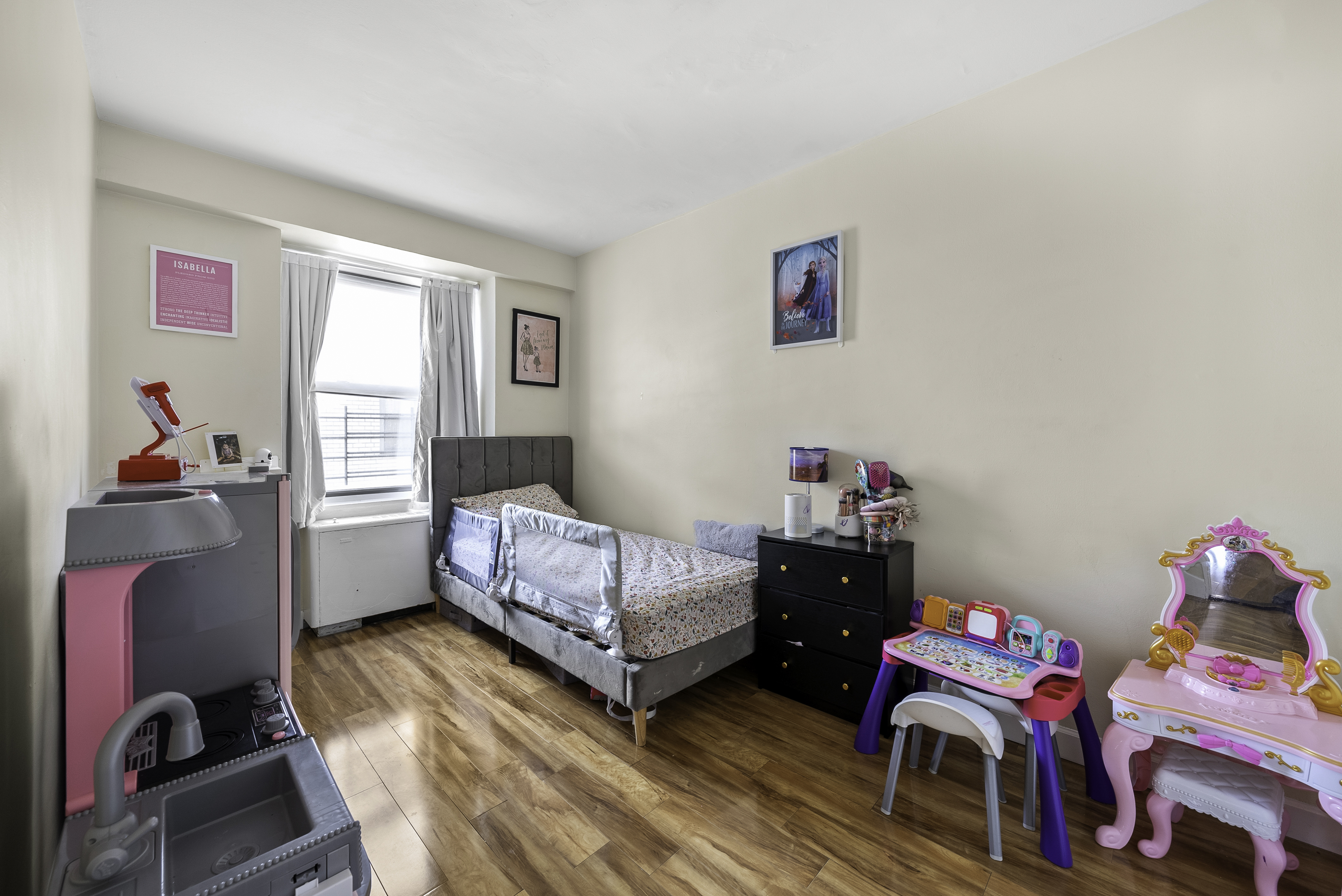 1020 Grand Concourse, Unit 5G Bronx, NY 10451 - Photo 7 of 11 a bedroom with furniture and a wooden floor