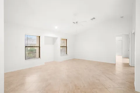 an empty room with windows and closet