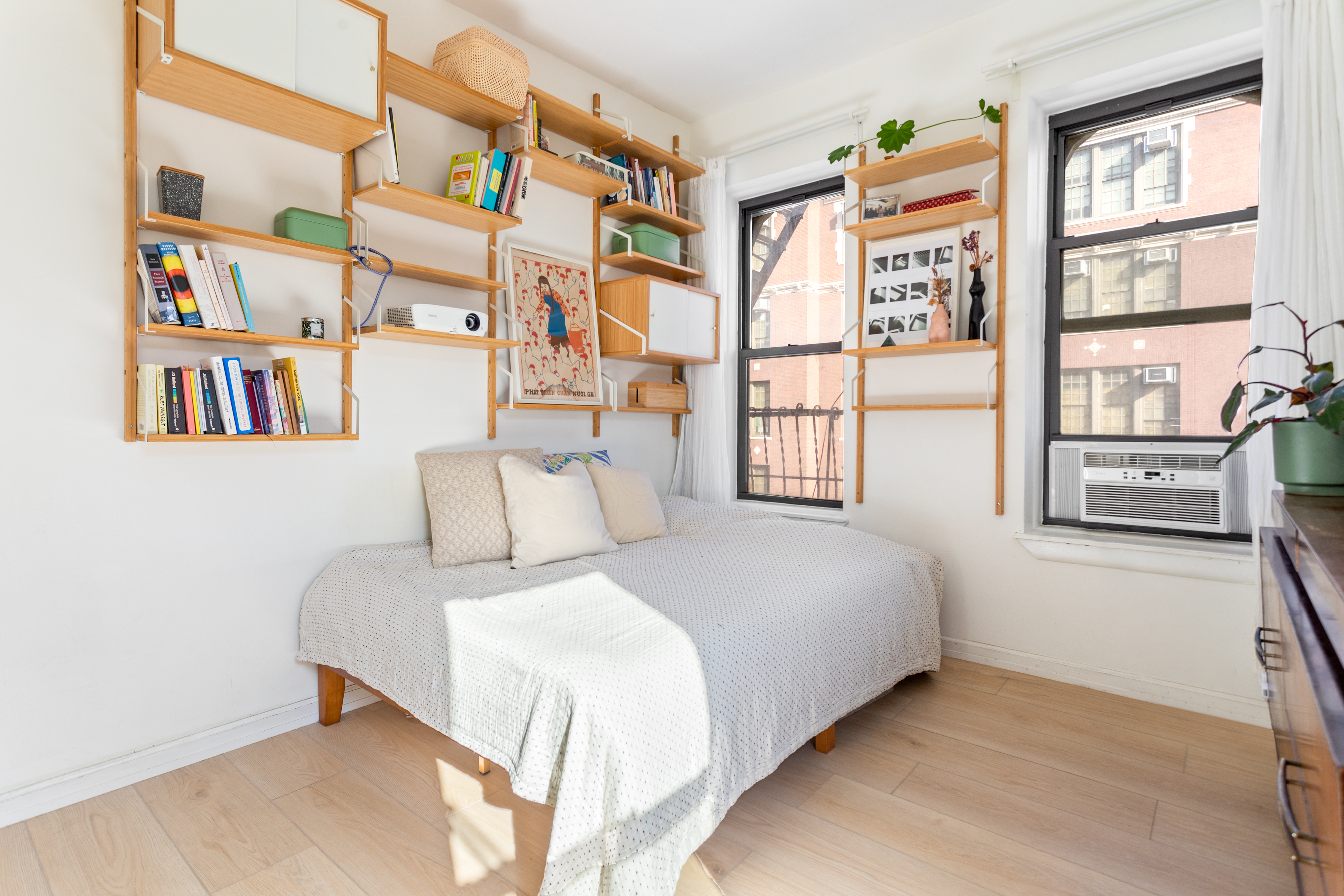 218 Scholes Street, Unit 12 Brooklyn, NY 11206 - Photo 3 of 8 a bedroom with a bed and a book shelf