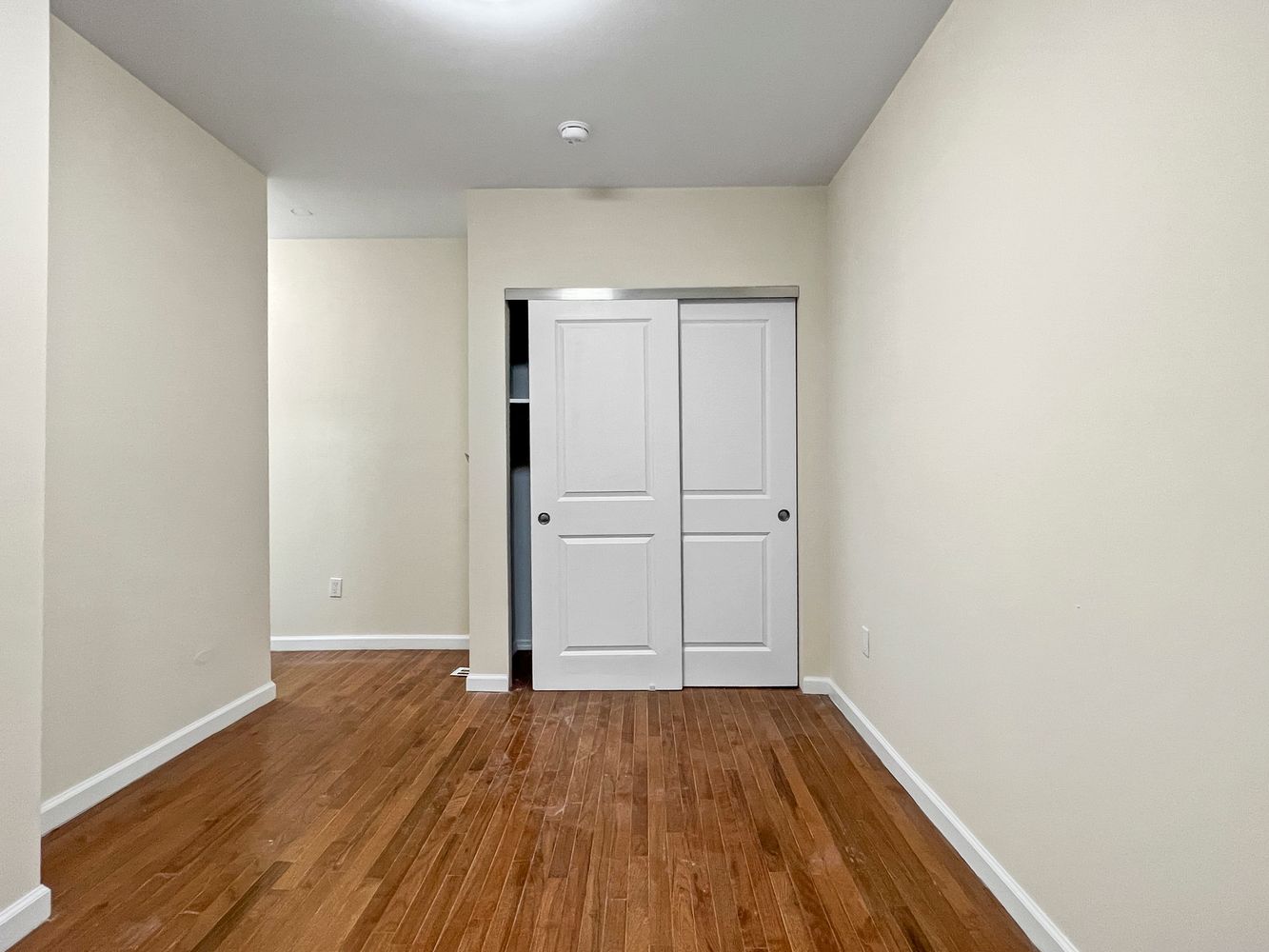 270 East 78th Street, Unit 1 Manhattan, NY 10075 - Photo 3 of 6 an empty room with wooden floor