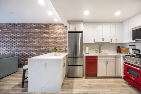 a kitchen with a sink cabinets and stainless steel appliances