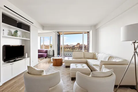 a living room with furniture a flat screen tv and a large window