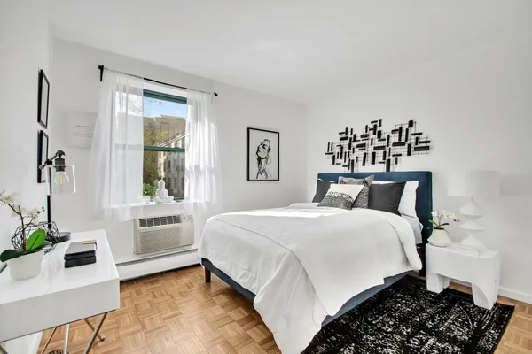 a bedroom with a large bed and a window