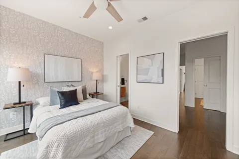 a bedroom with a bed and a painting on the wall