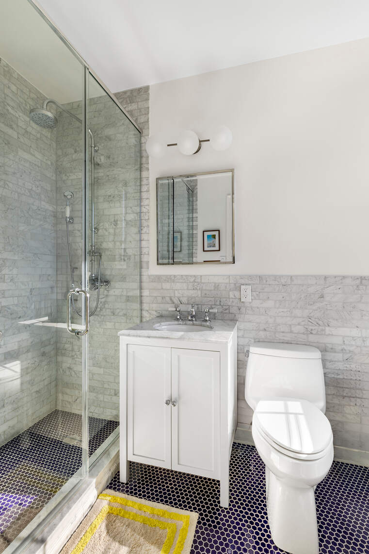 47 Plaza Street West, Unit 5B Brooklyn, NY 11217 - Photo 13 of 14 a bathroom with a sink a toilet and shower