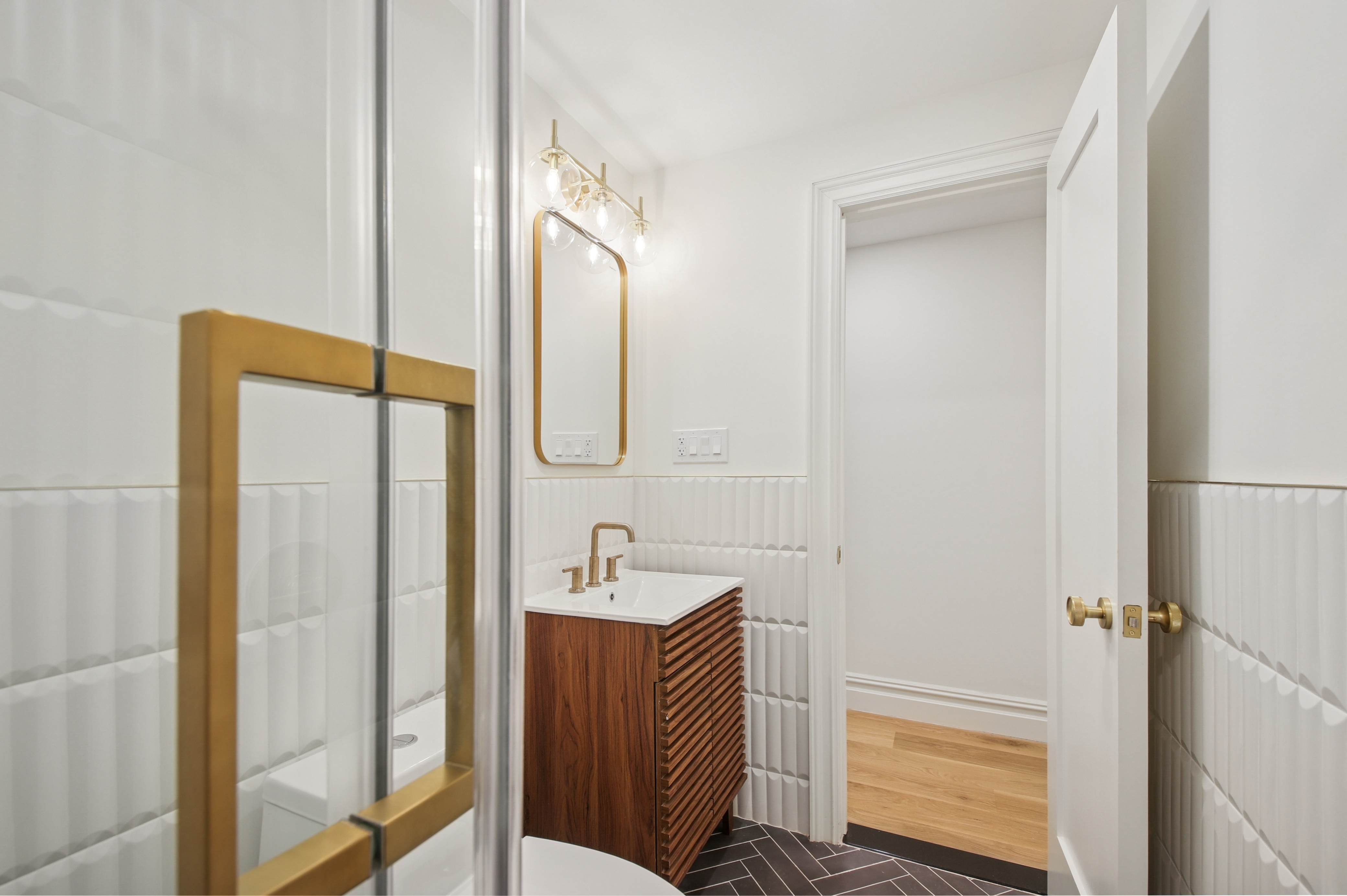 239 Madison Street, Unit 1 Brooklyn, NY 11216 - Photo 11 of 14 a bathroom with a sink and a mirror