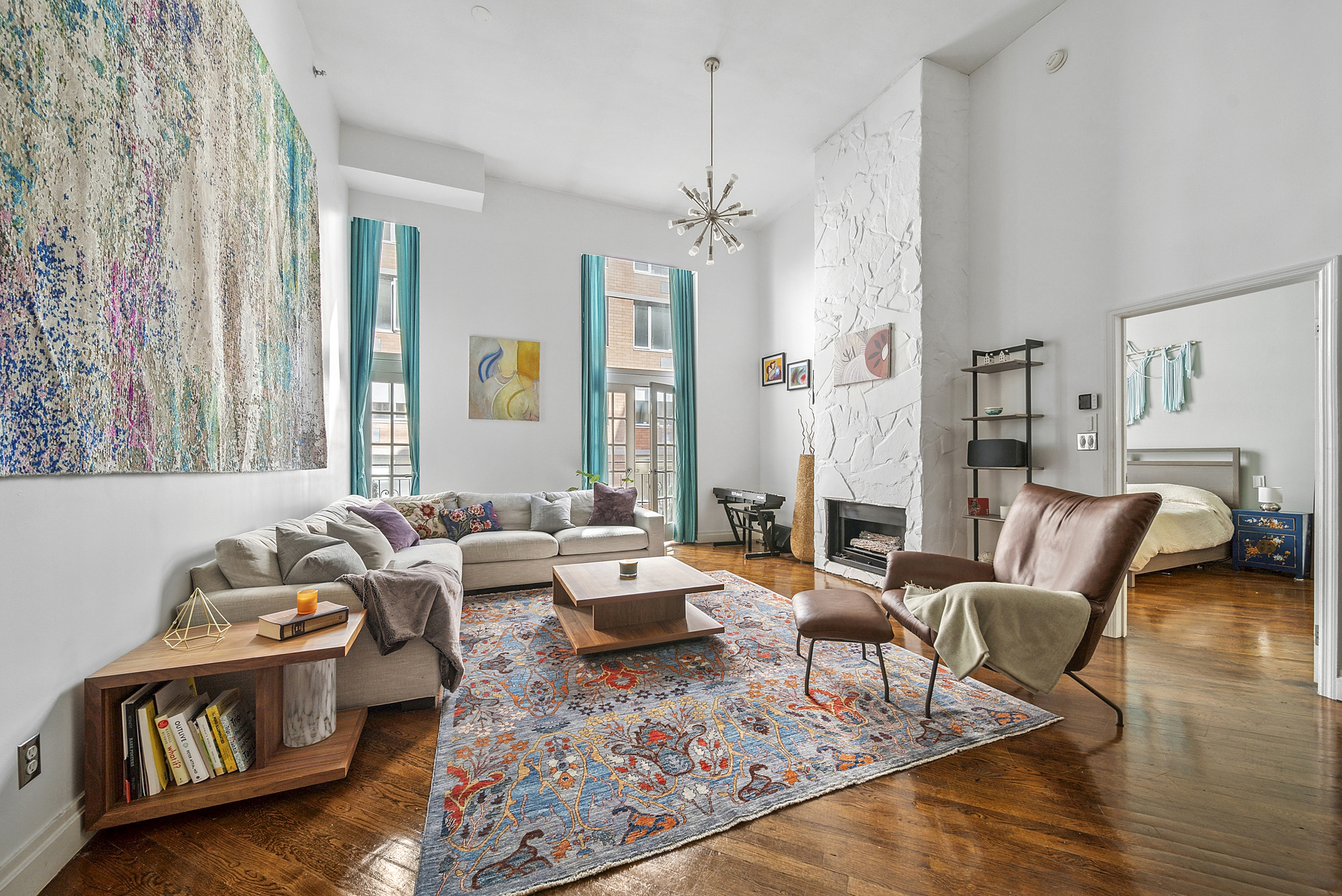 a living room with furniture and wooden floor