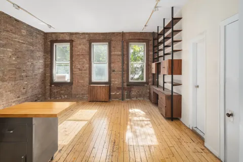 a spacious bedroom with a large bed and a chandelier