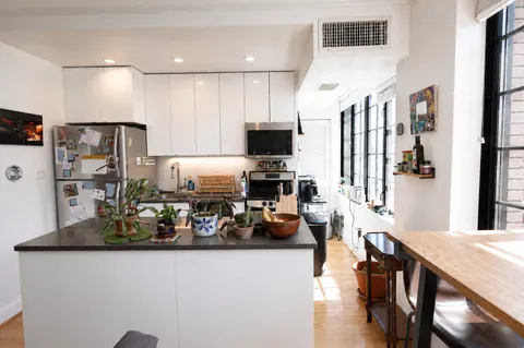 a kitchen with stainless steel appliances granite countertop a refrigerator and a stove top oven