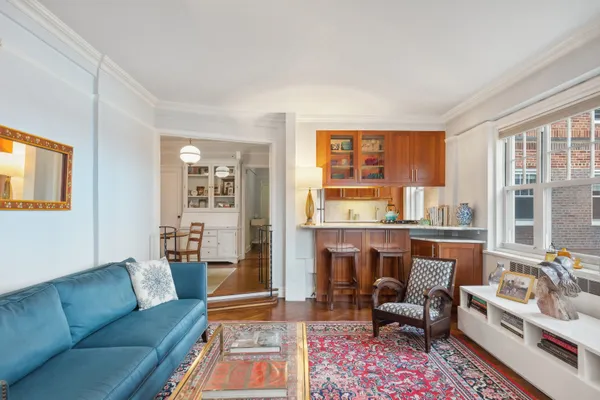 a living room with furniture and a floor to ceiling window