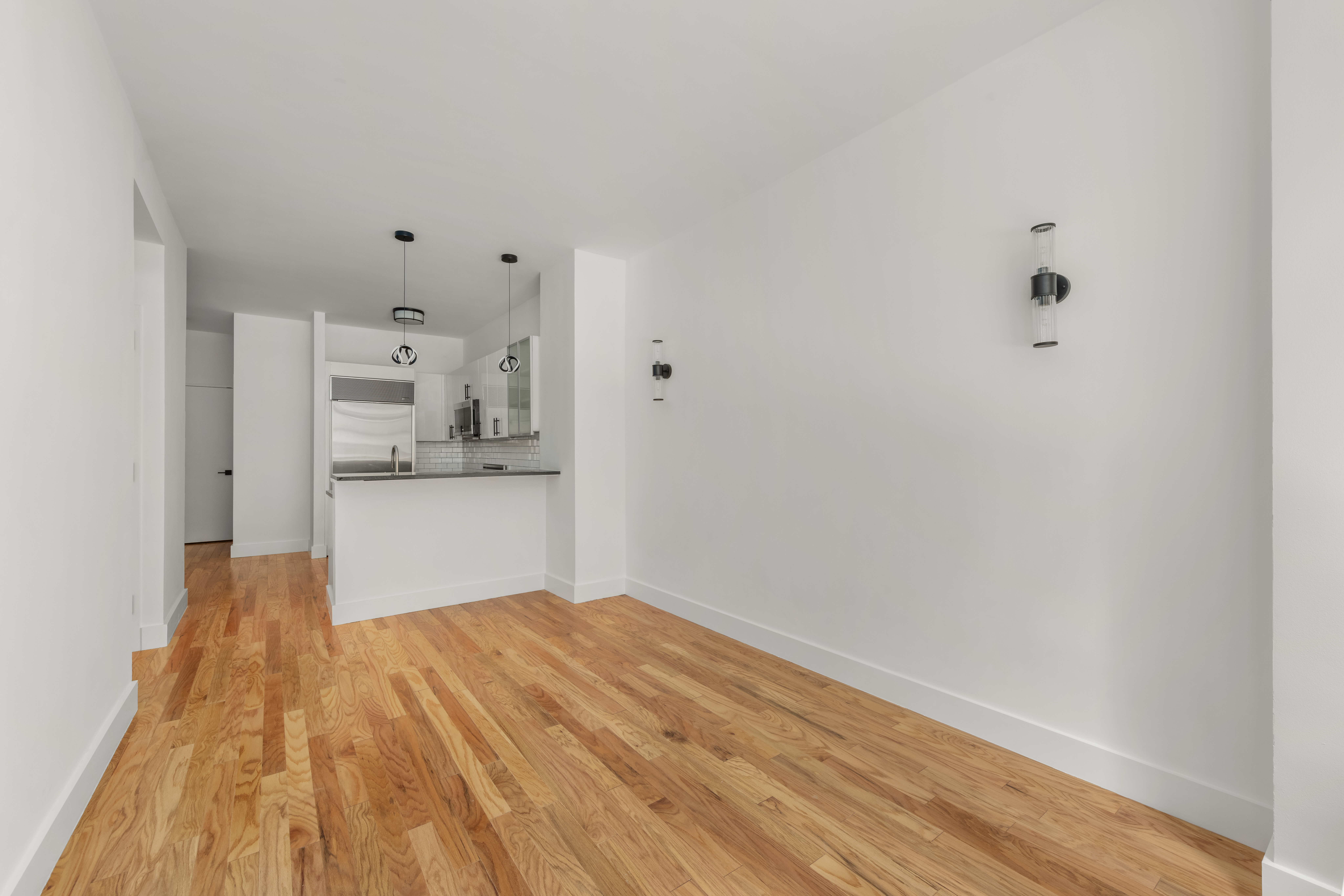 212 East 57th Street, Unit 3B Manhattan, NY 10022 - Photo 3 of 17 a view of kitchen and wooden floor