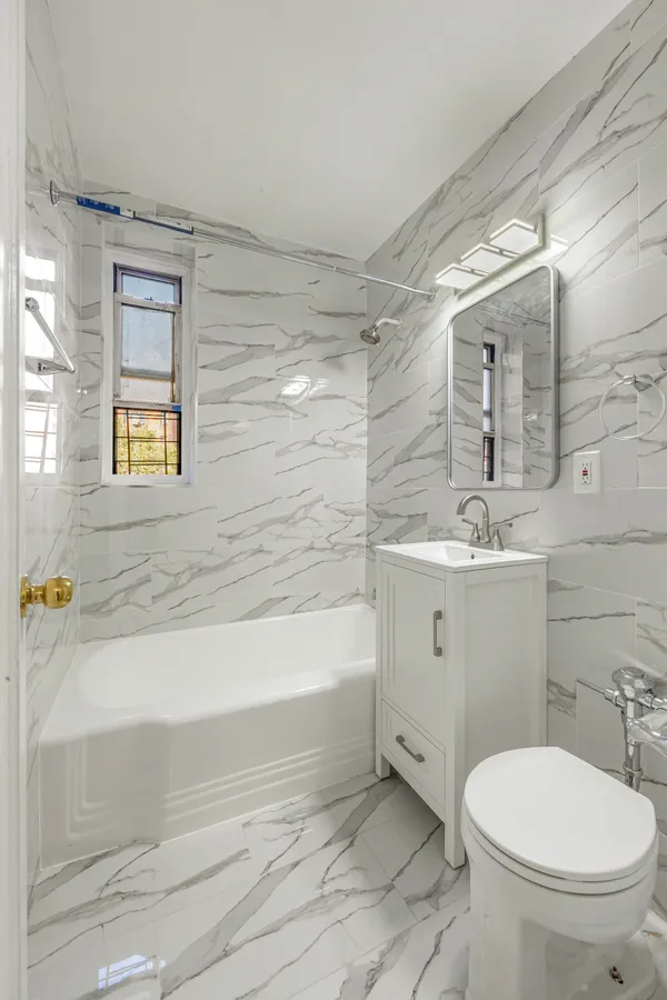 a bathroom with a sink a toilet and bathtub