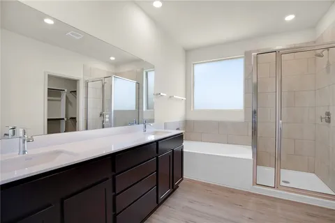 a bathroom with a double vanity sink mirror and shower