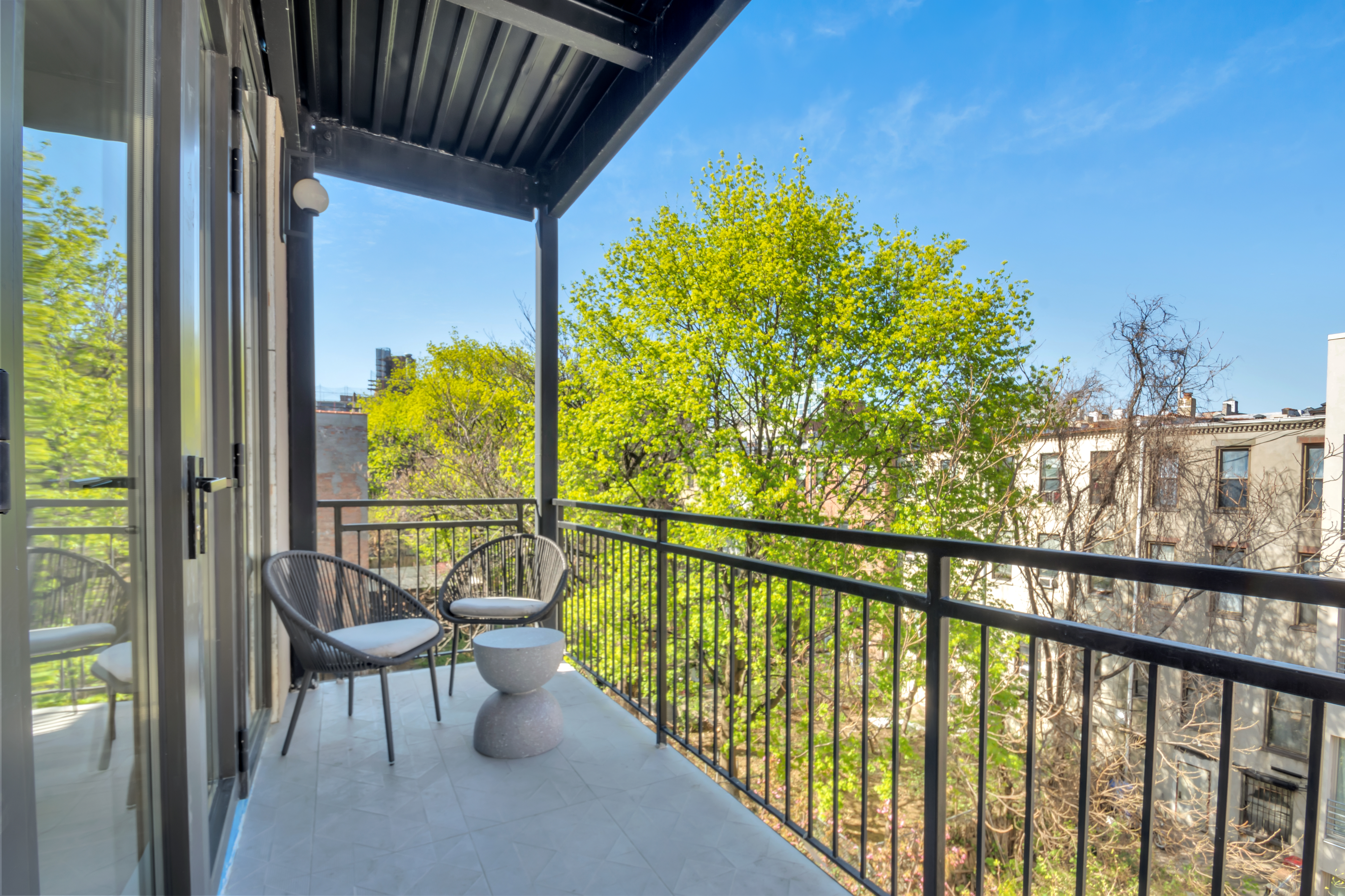 145 West 129th Street, Unit 6 Manhattan, NY 10027 - Photo 8 of 16 a view of a balcony with furniture