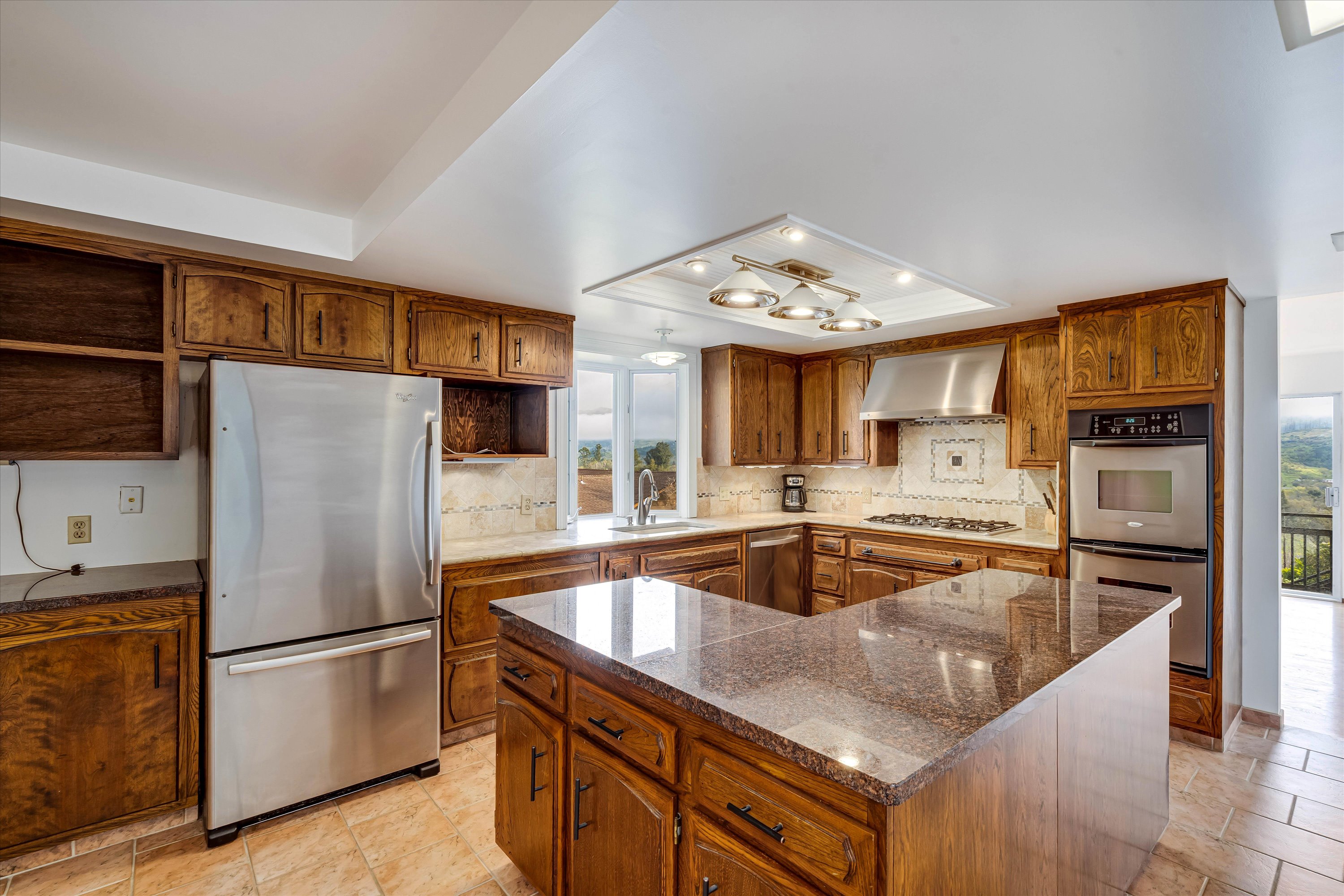 1291 Rockland Drive St. Helena, CA 94574 - Photo 6 of 26 a kitchen with granite countertop a refrigerator and a sink