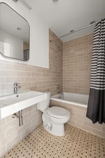 a bathroom with a toilet a sink and bathtub