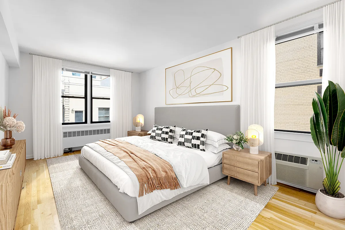85 4th Avenue, Unit 2LL Manhattan, NY 10003 - Photo 2 of 7 a bedroom with a bed table flowerpot and window