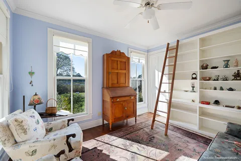 a bedroom with two beds and painting on the wall
