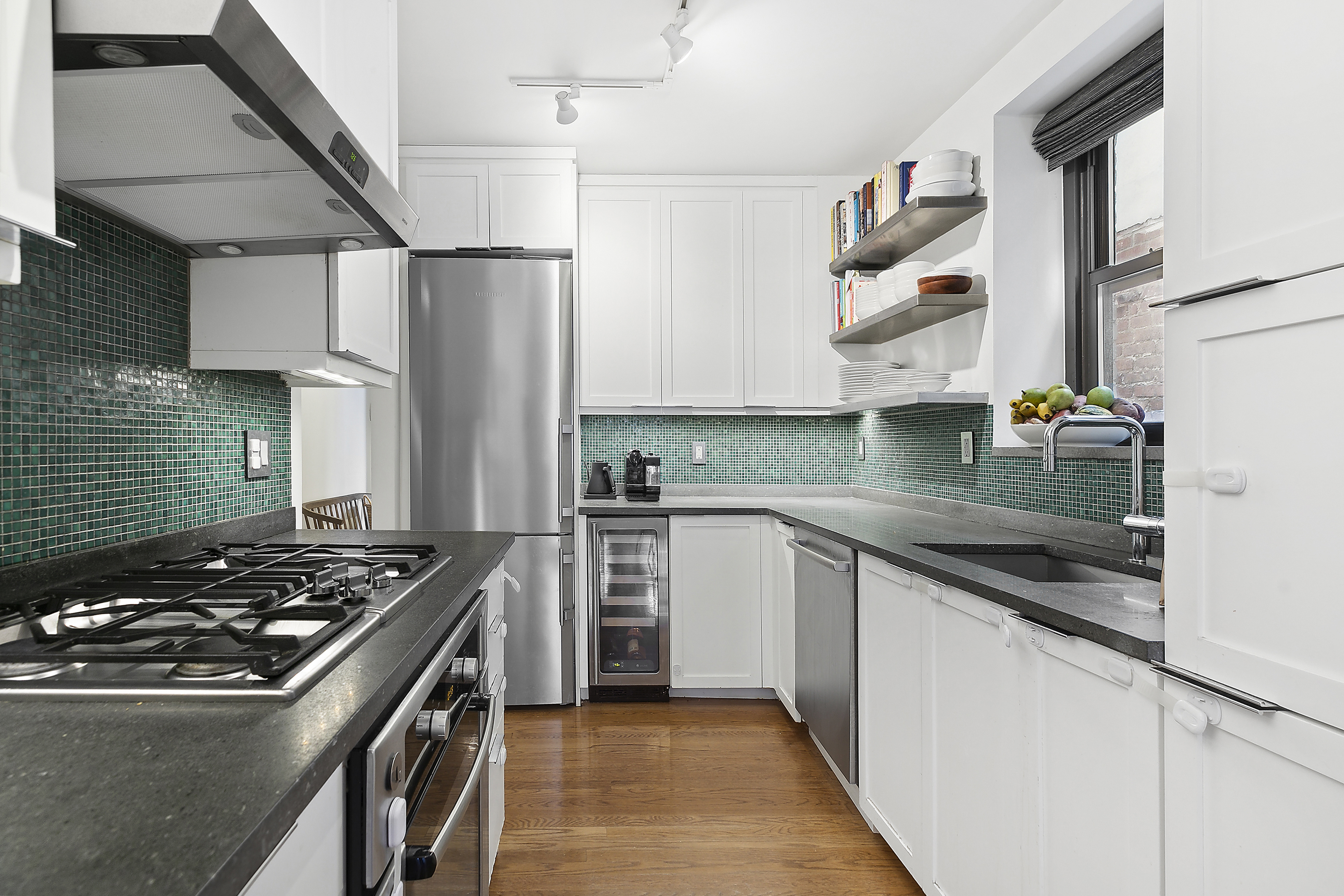 422 West 20th Street, Unit 5A Manhattan, NY 10011 - Photo 3 of 14 a kitchen with stainless steel appliances granite countertop a stove and a sink