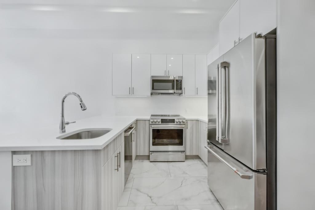 109 President Street, Unit 2 Brooklyn, NY 11231 - Photo 7 of 20 a kitchen with stainless steel appliances granite countertop a refrigerator sink and stove