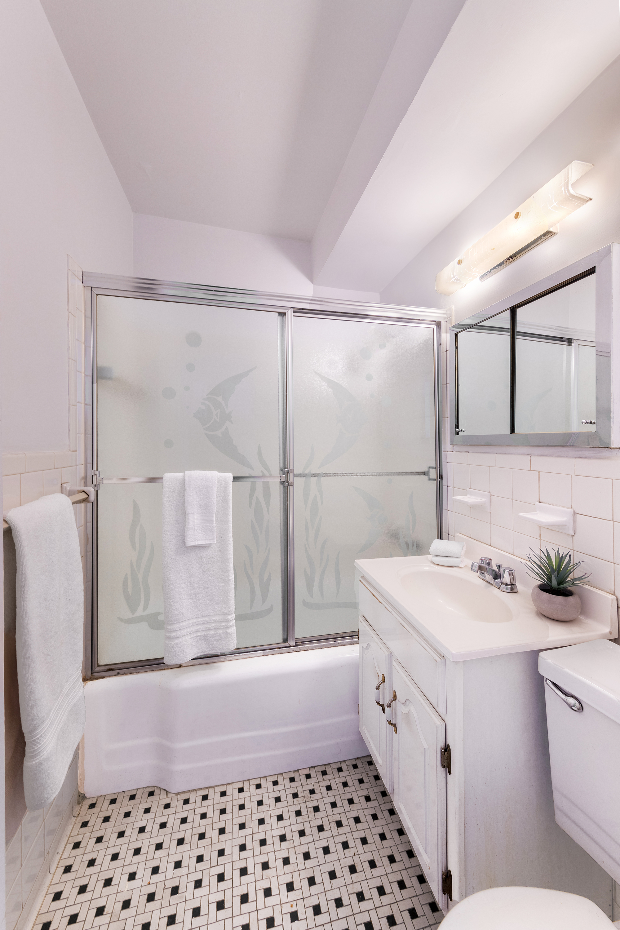 311 East 71st Street, Unit 3F Manhattan, NY 10021 - Photo 5 of 6 a bathroom with a sink a toilet and shower