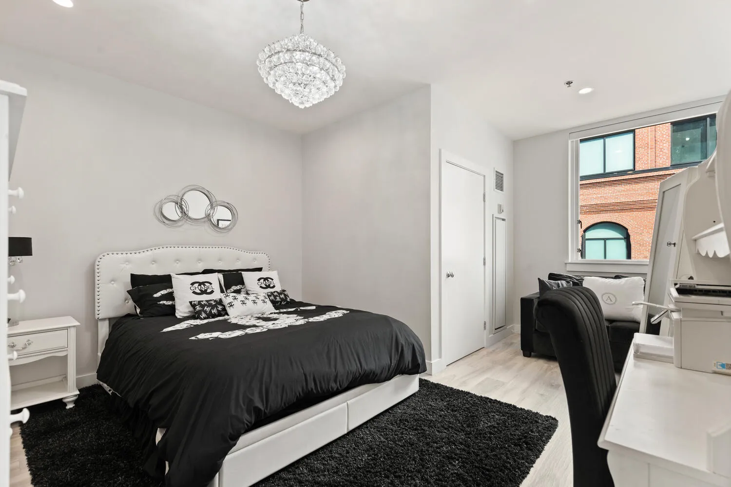 a bedroom with a bed and wooden floor