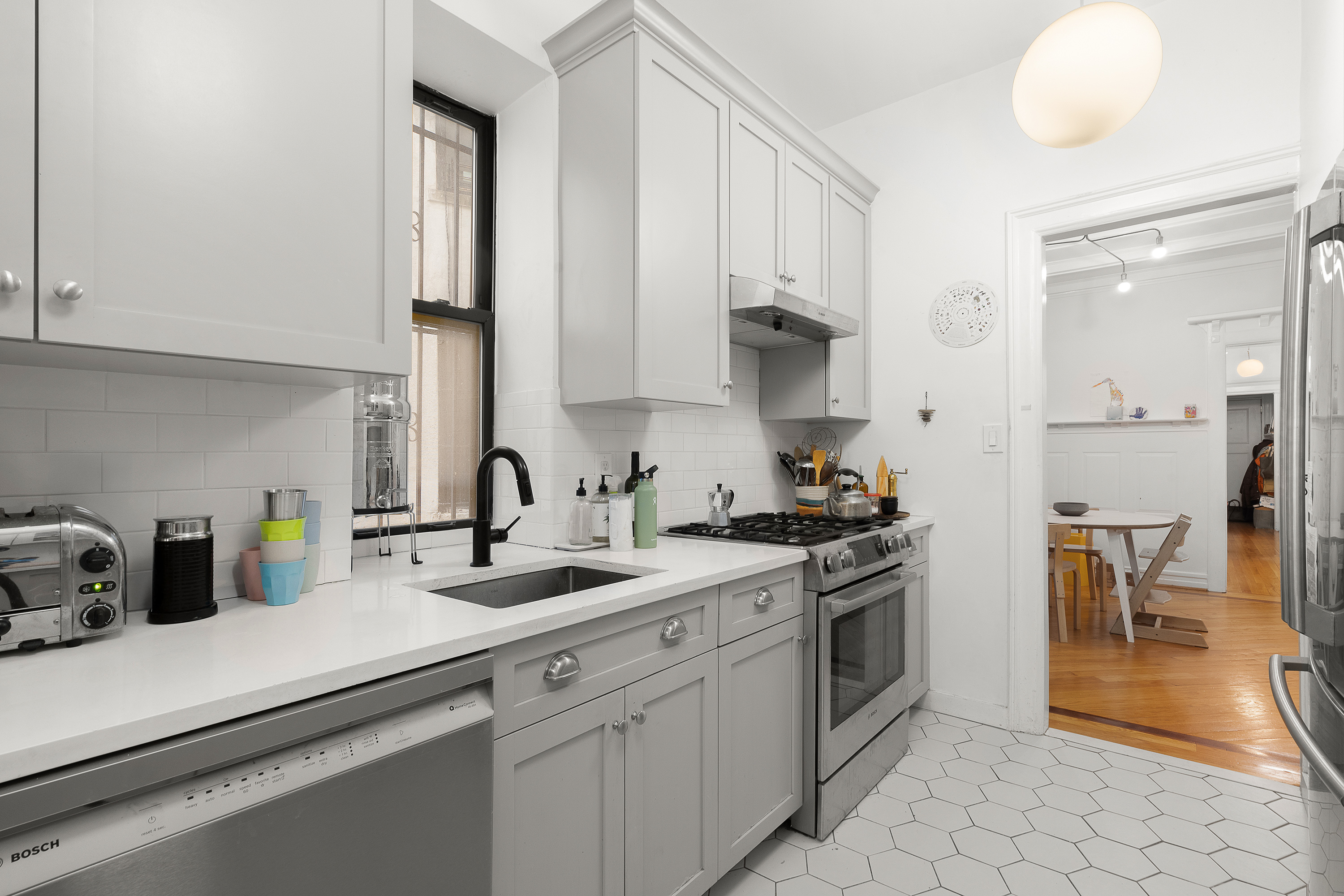 226 St James Place, Unit 1R Brooklyn, NY 11238 - Photo 6 of 14 a kitchen with stainless steel appliances granite countertop a sink a stove and a refrigerator