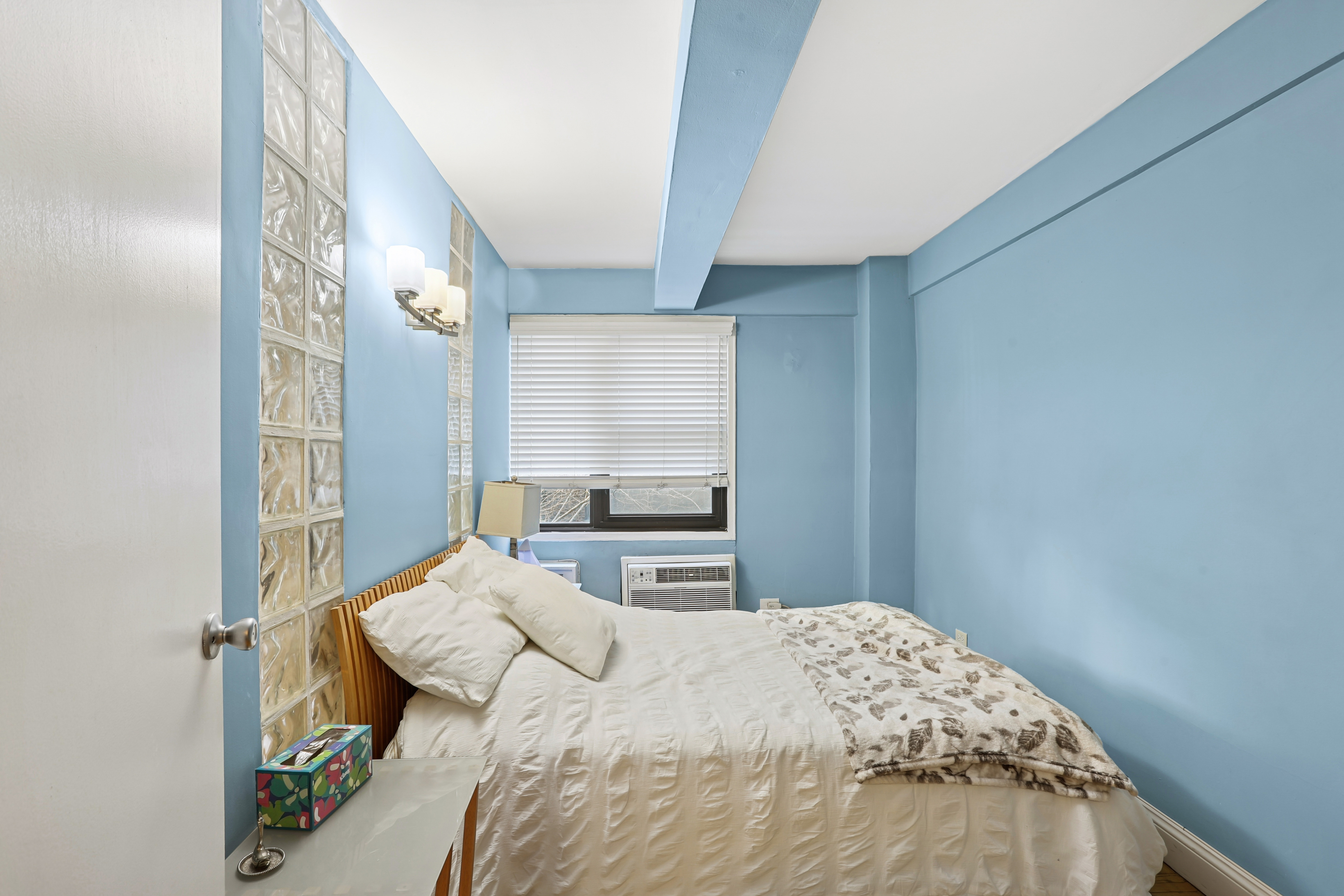 335 East 51st Street, Unit 4H Manhattan, NY 10022 - Photo 7 of 13 a bedroom with a bed and a mirror