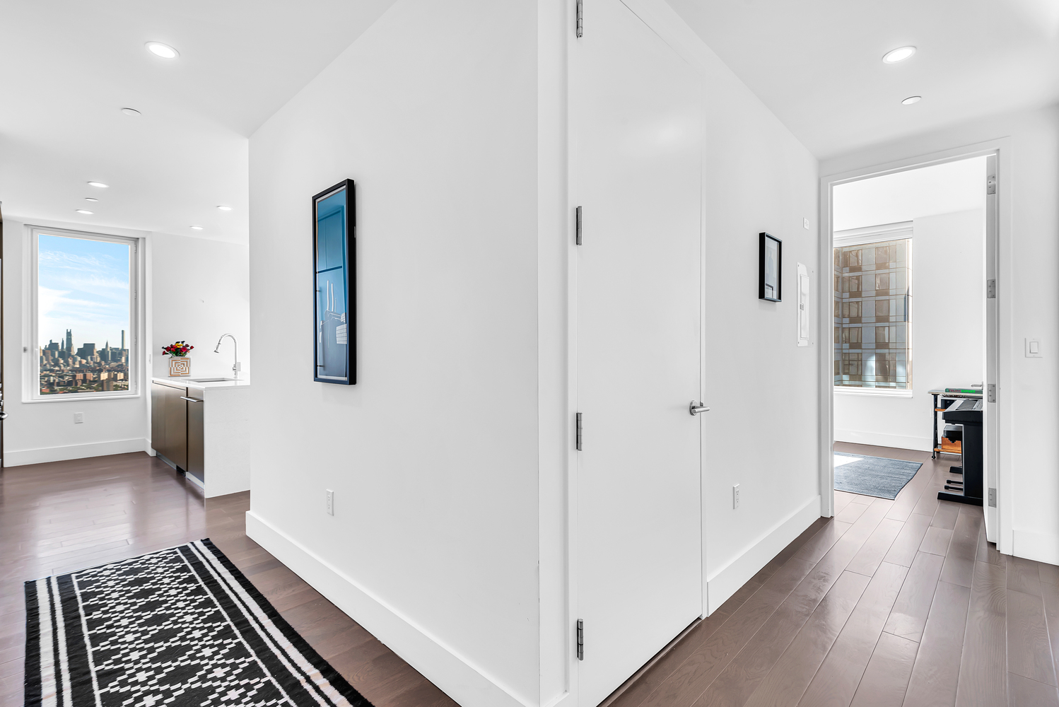 388 Bridge Street, Unit 35G Brooklyn, NY 11201 - Photo 5 of 27 a view of a hallway with wooden floor and furniture