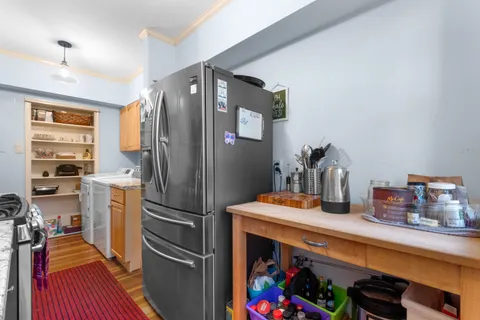 a kitchen with a refrigerator and a stove