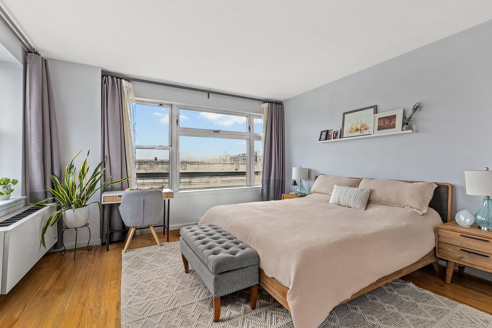 4102 Queens Boulevard, Unit 3D Queens, NY 11104 - Photo 3 of 7 a bedroom with a bed and a large window