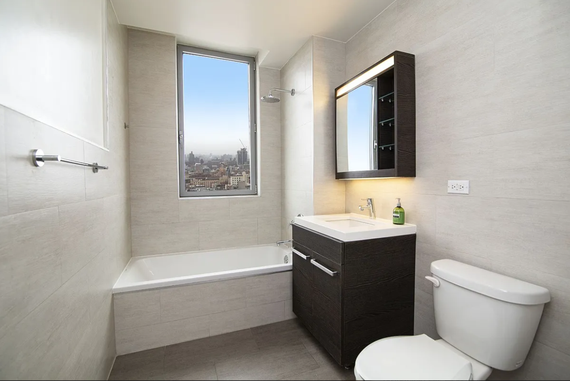 321 West 110th Street, Unit 17B Manhattan, NY 10026 - Photo 3 of 5 a bathroom with a sink toilet and vanity