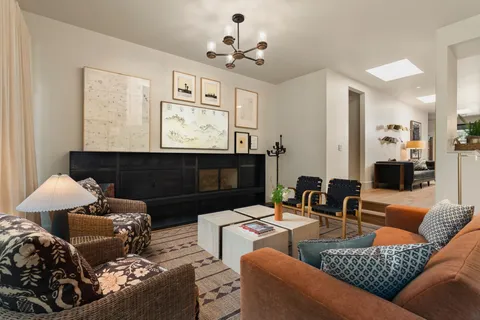 a living room with furniture tv and a window