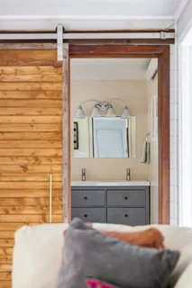 a bedroom with a bed and a mirror