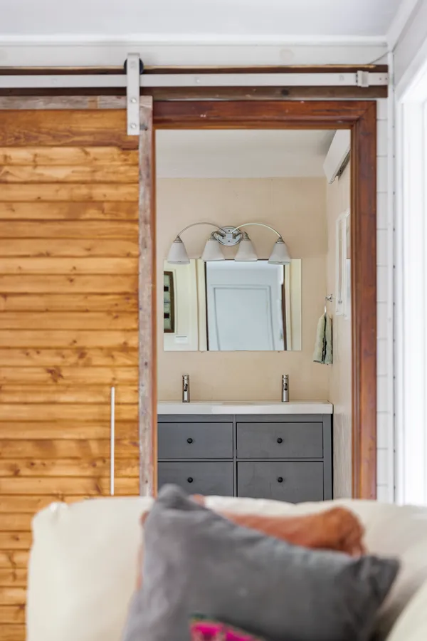 a bedroom with a bed and a mirror