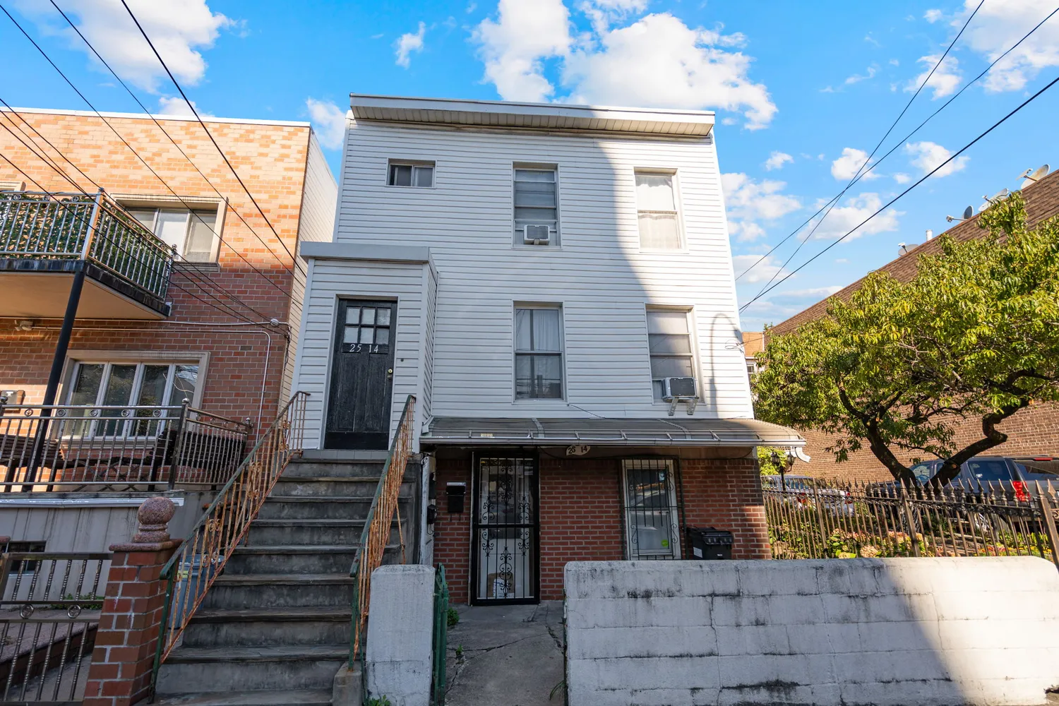 a view of a house with wooden deck front of house