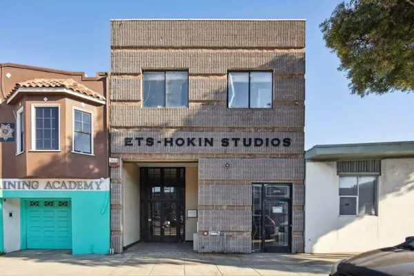 a front view of a building with garden