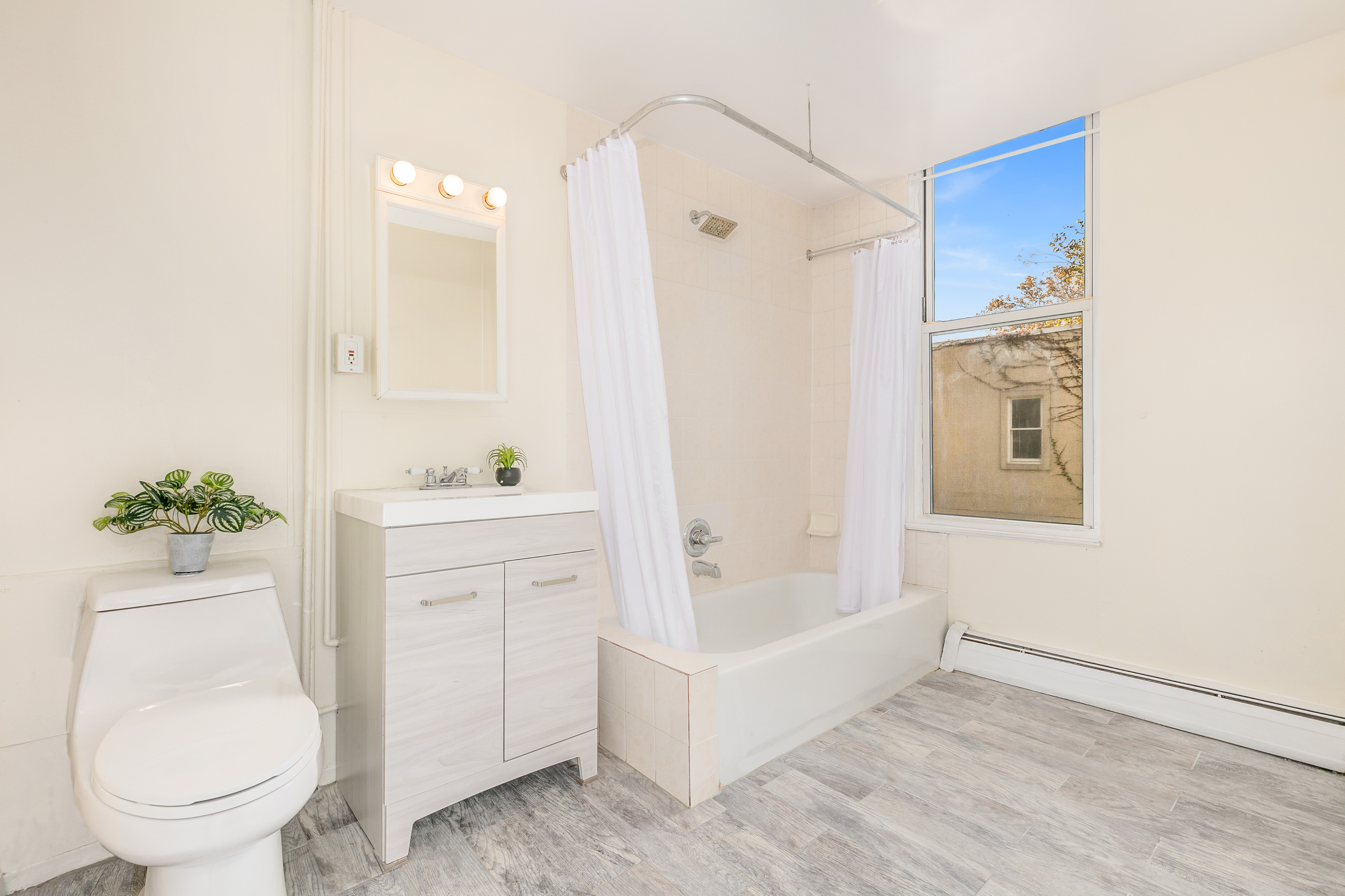 148 29th Street Brooklyn, NY 11232 - Photo 9 of 31 a bathroom with a bathtub shower sink and toilet