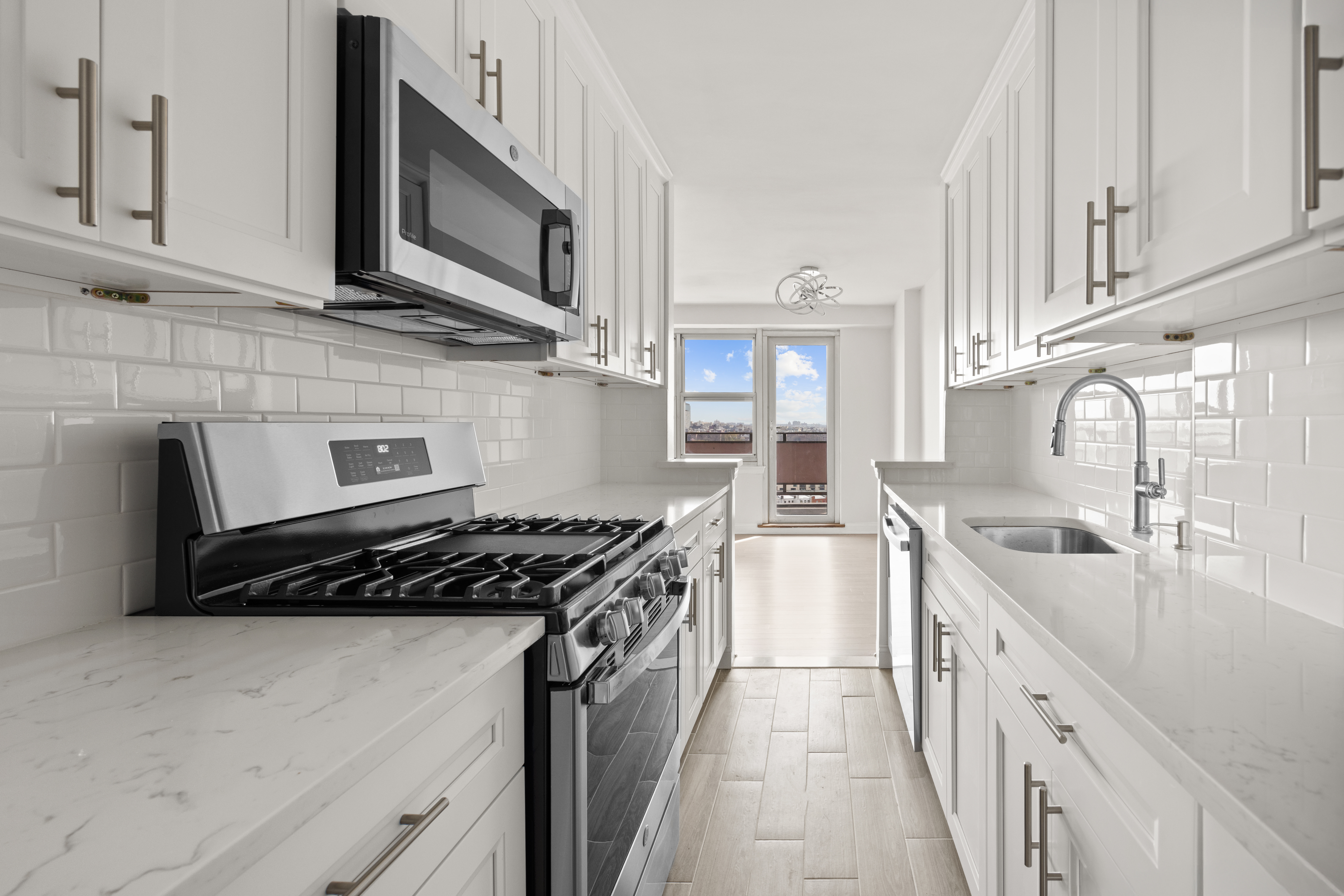 135 Ocean Parkway, Unit 16N Brooklyn, NY 11218 - Photo 7 of 16 a kitchen with stainless steel appliances granite countertop a sink stove and cabinets
